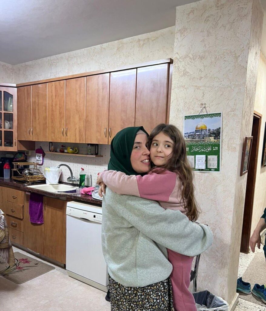 Liberated Palestinian journalist Bushra al-Tawil embraces her younger sister after her liberation from her seventh imprisonment in Toufan al-Ahrar