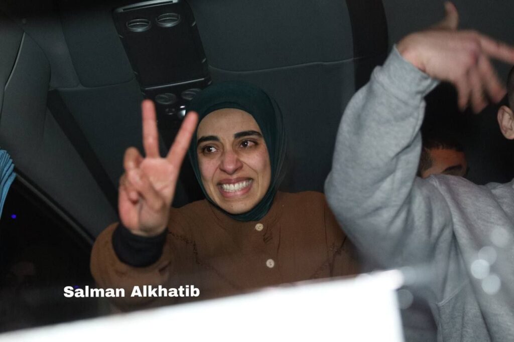 Palestinian liberated journalist Rula Hassanein -- separated from her infant daughter Elia by the occupation -- raises the victory sign
